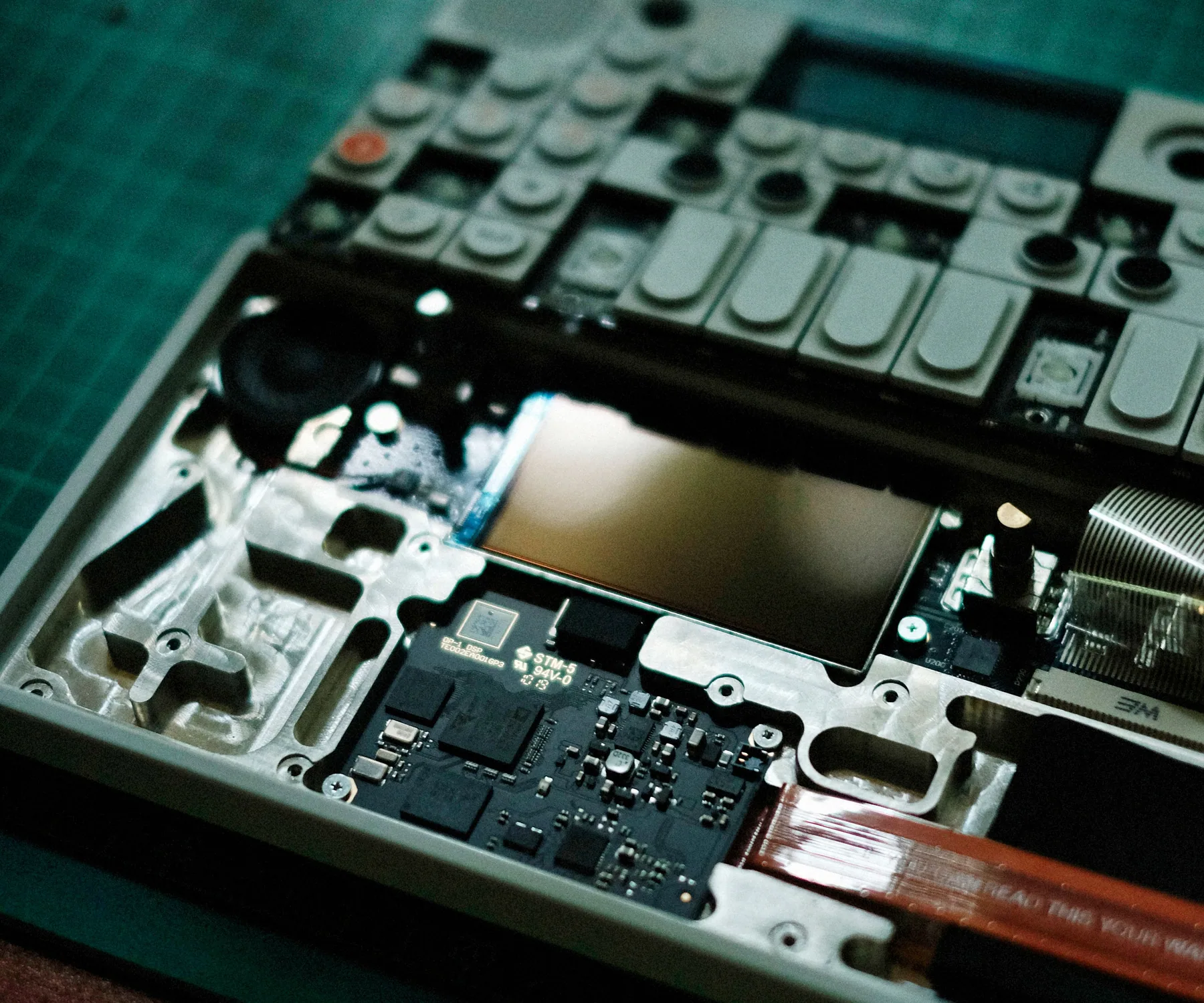 Partially disassembled electronic audio device with its circuit board exposed
